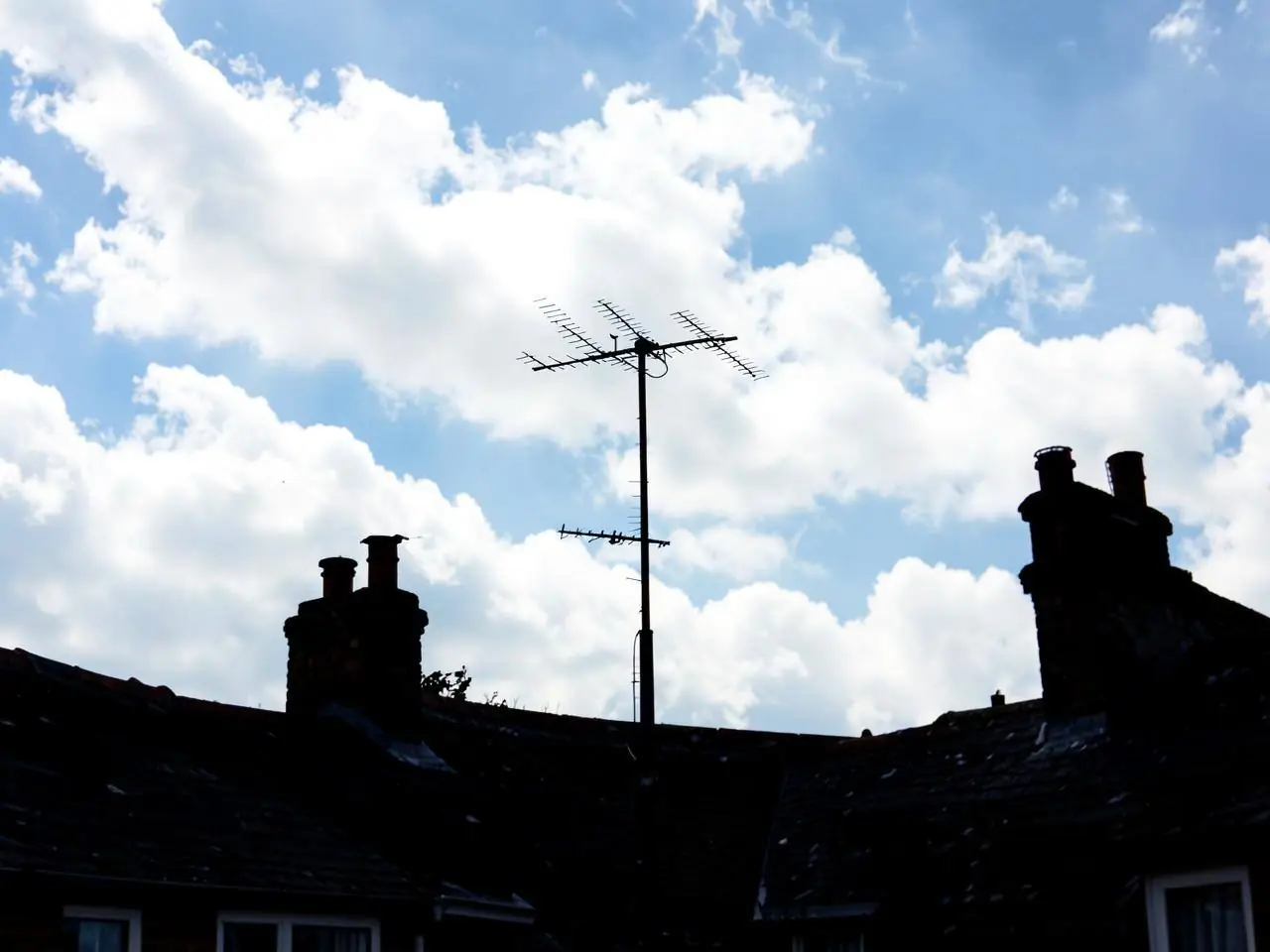 Television aerial fitted above a rooftop in Witney